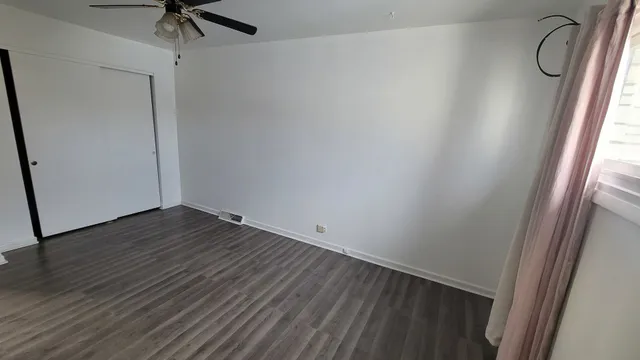 a view of small space with wooden floor and entryway