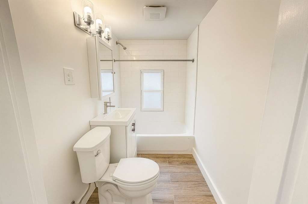 145 Lagrange Street, Unit 2 Boston, MA 02132 - Photo 12 of 17 a white toilet sitting next to a bathroom sink