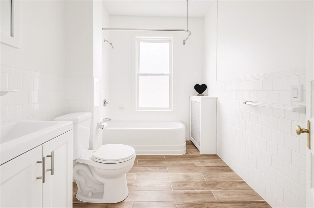 145 Lagrange Street, Unit 2 Boston, MA 02132 - Photo 8 of 17 a bathroom with a toilet a sink and a bathtub