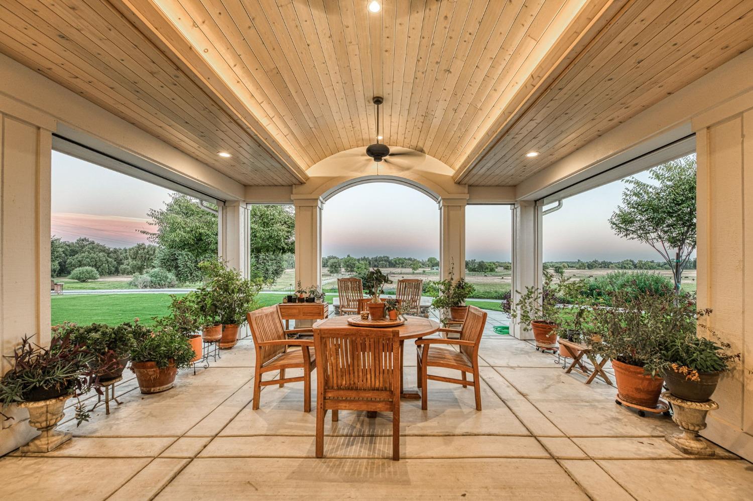 1098 South Rainbow Route Sanger, CA 93657 - Photo 30 of 70 a view of a patio with a table chairs and garden