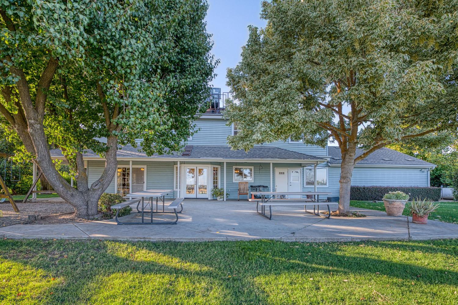 1098 South Rainbow Route Sanger, CA 93657 - Photo 34 of 70 a front view of a house with a yard and outdoor seating