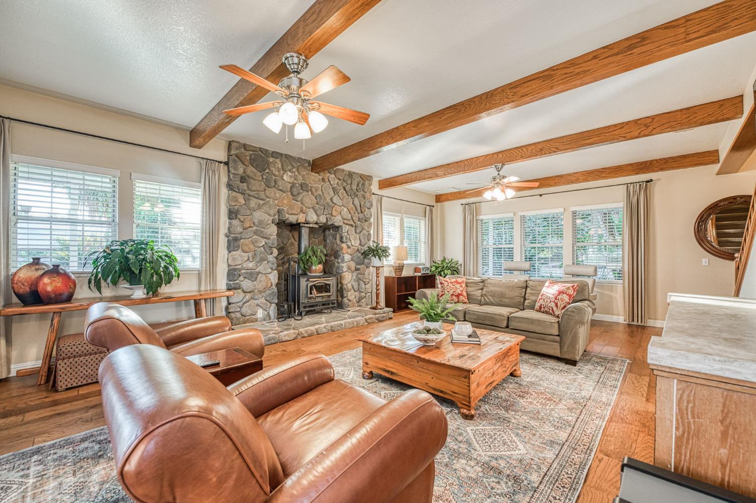 1098 South Rainbow Route Sanger, CA 93657 - Photo 37 of 70 a living room with furniture a chandelier and a large window