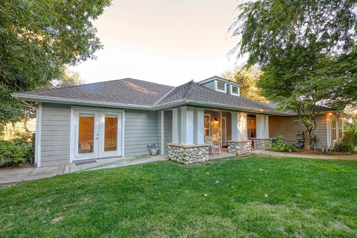 1098 South Rainbow Route Sanger, CA 93657 - Photo 51 of 70 a front view of a house with a garden and outdoor seating