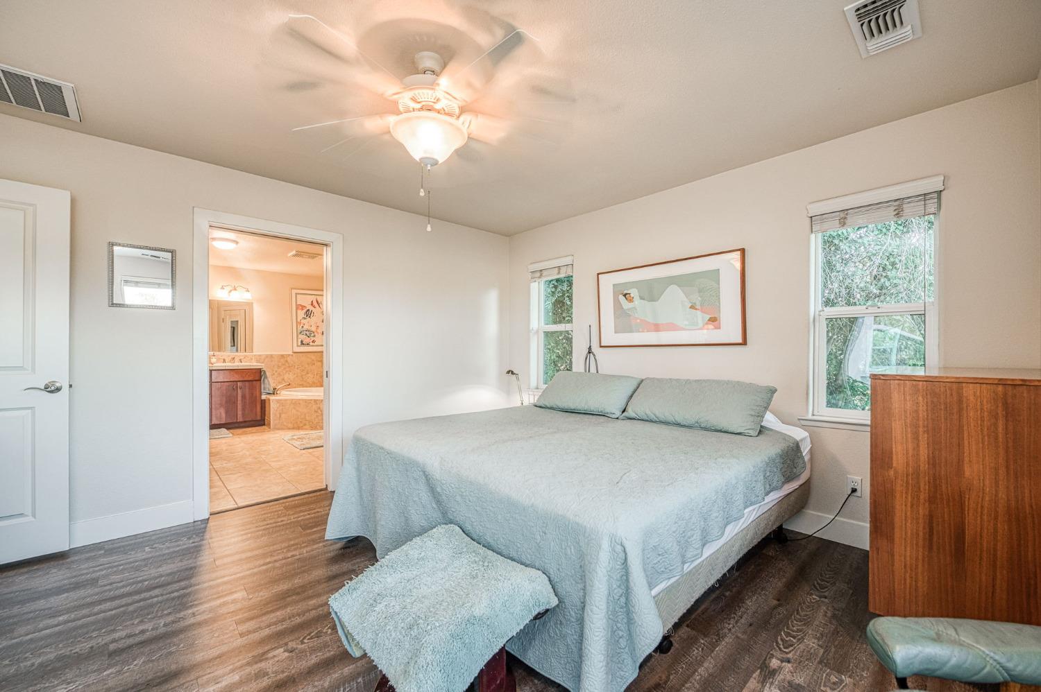 1098 South Rainbow Route Sanger, CA 93657 - Photo 59 of 70 a bedroom with a large bed and a chandelier