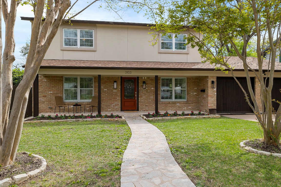 a front view of a house with a yard