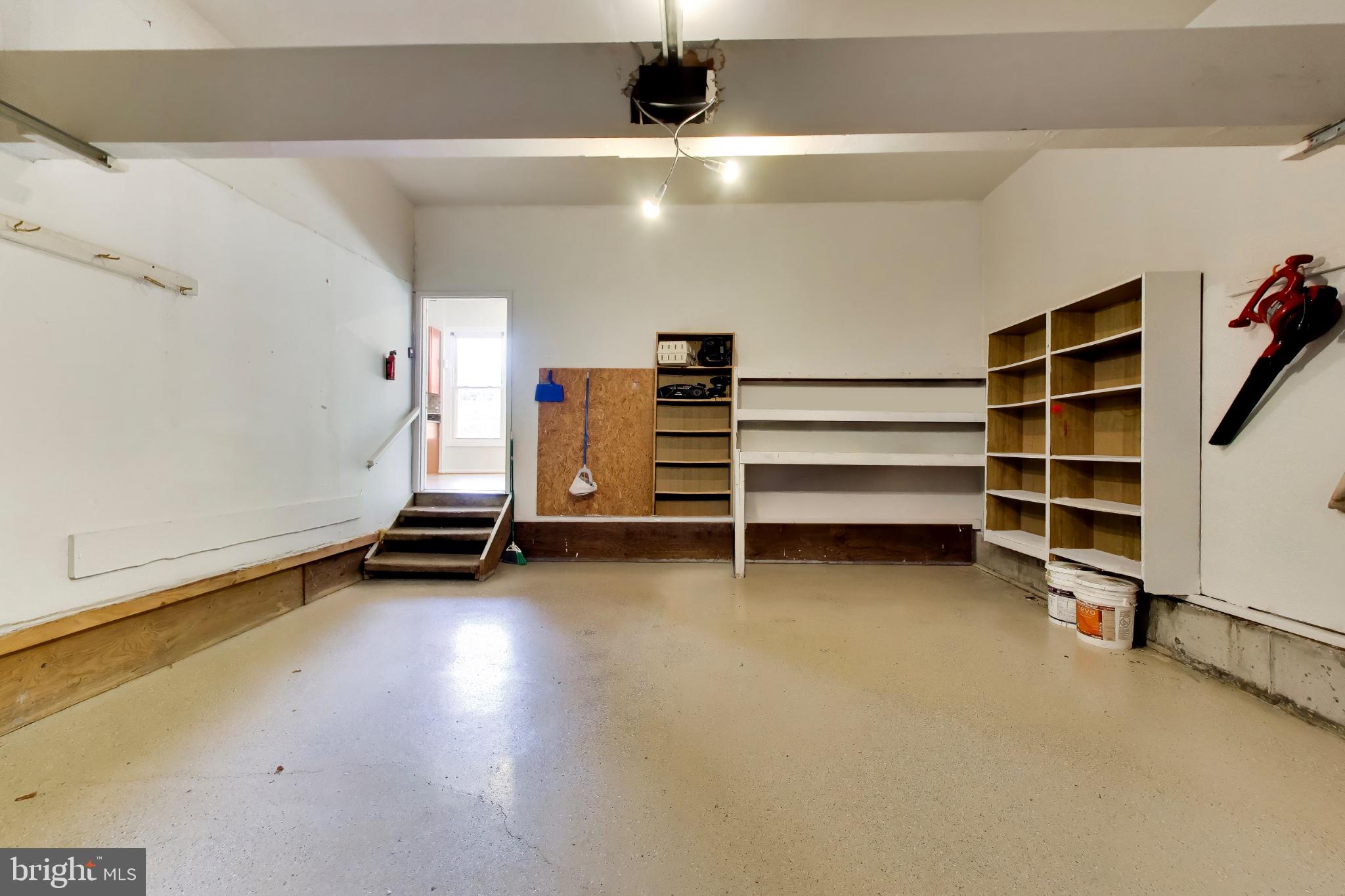 11906 Claridge Road Silver Spring, MD 20902 - Photo 36 of 41 2-car garage with extra storage space & shelving