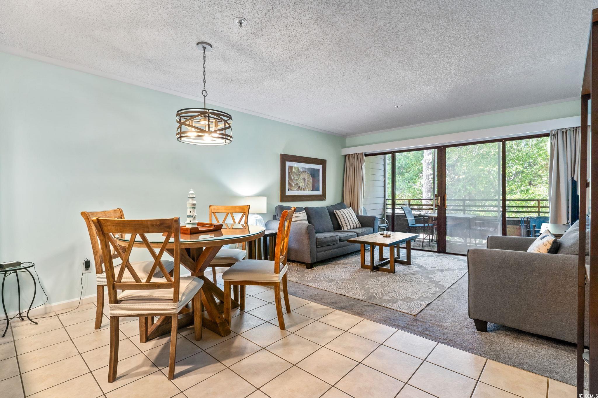 415 Ocean Creek Drive, Unit 2343 Myrtle Beach, SC 29572 - Photo 14 of 36 Dining area with a textured ceiling and light tile patterned floors
