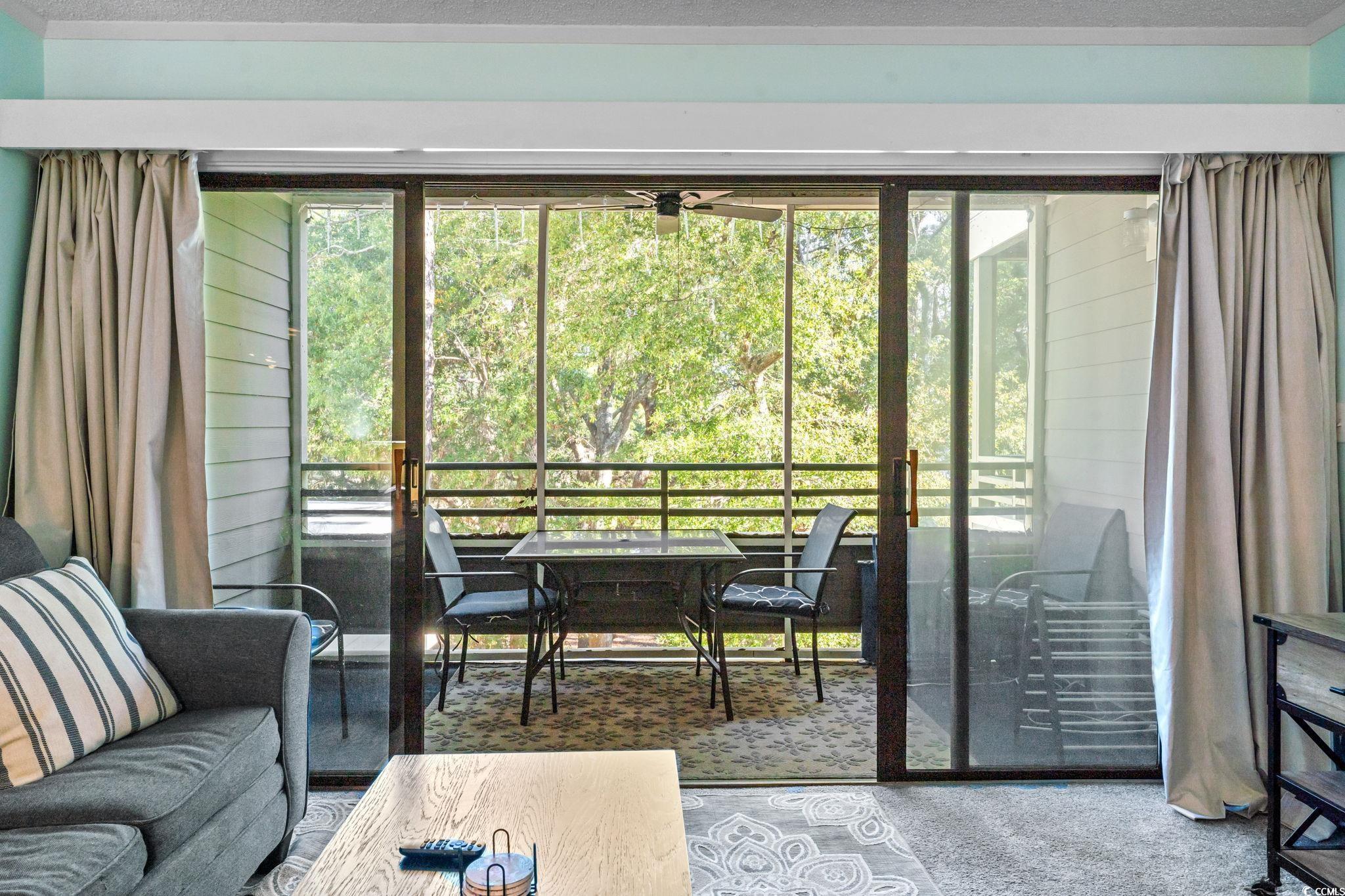 415 Ocean Creek Drive, Unit 2343 Myrtle Beach, SC 29572 - Photo 21 of 36 Doorway with healthy amount of natural light, carpet flooring, and a ceiling fan