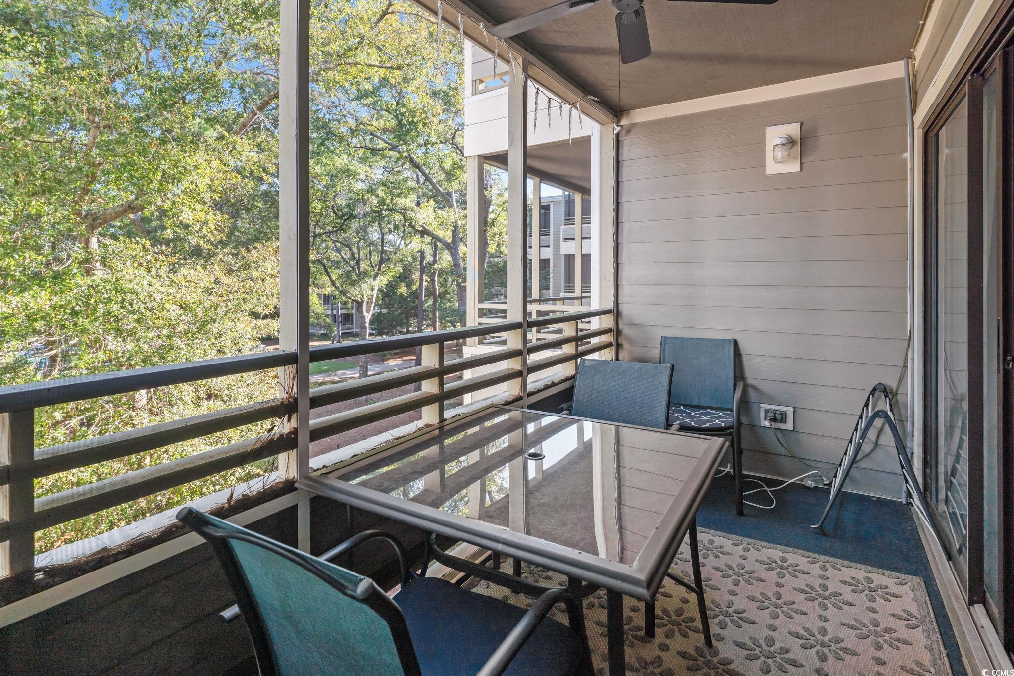 415 Ocean Creek Drive, Unit 2343 Myrtle Beach, SC 29572 - Photo 25 of 36 Sunroom / solarium with a balcony, ceiling fan, and outdoor dining space