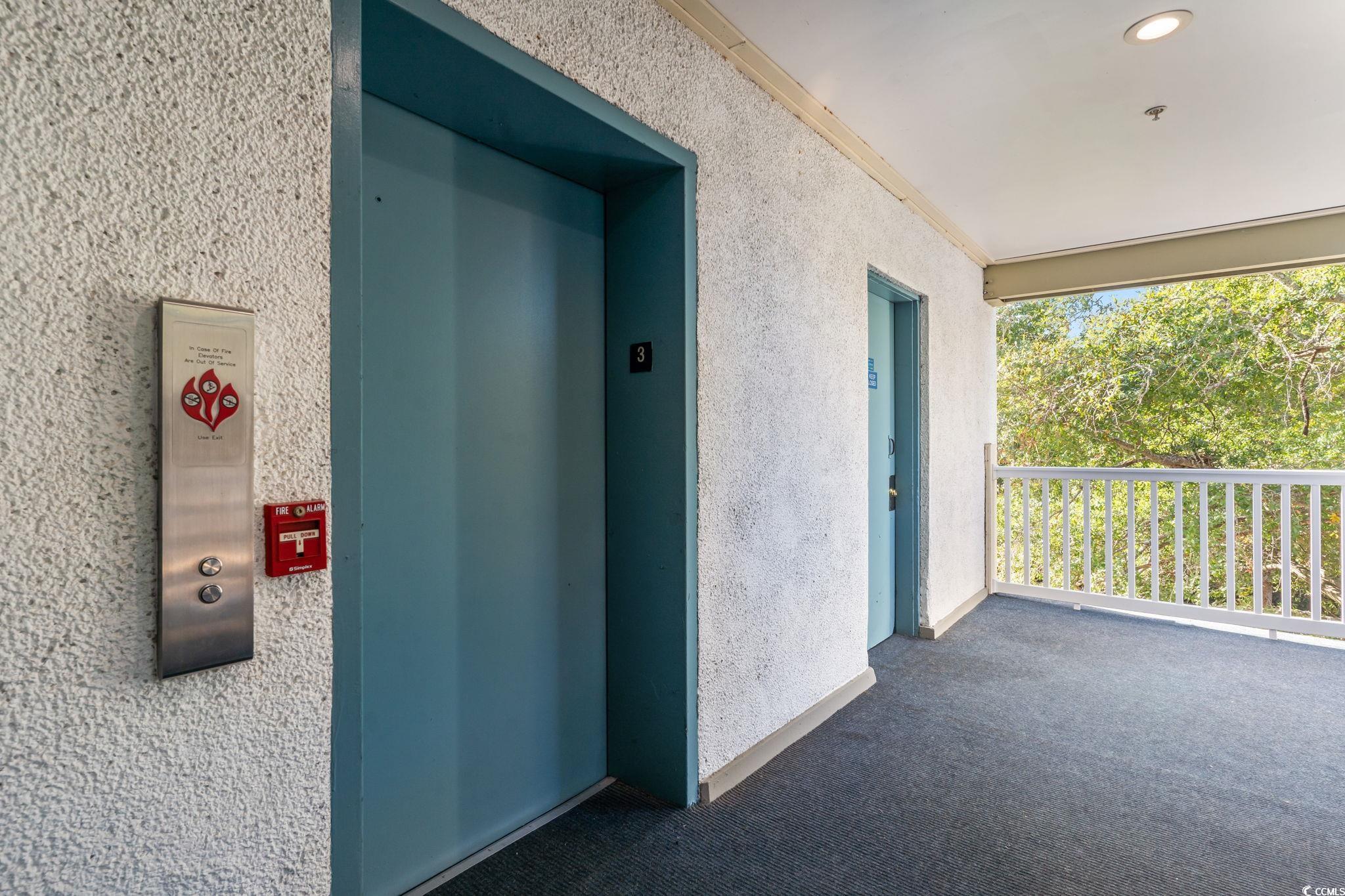 415 Ocean Creek Drive, Unit 2343 Myrtle Beach, SC 29572 - Photo 27 of 36 Entrance to property with elevator and stucco siding