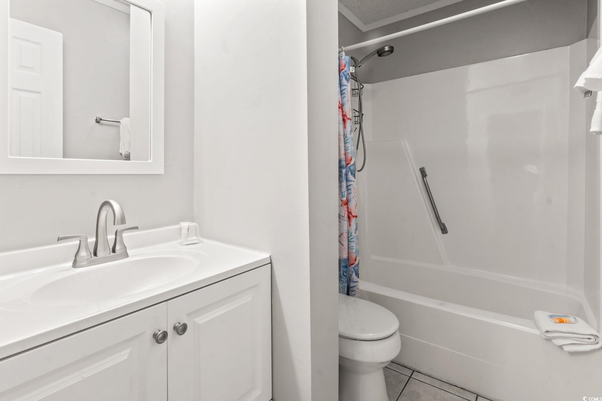 415 Ocean Creek Drive, Unit 2343 Myrtle Beach, SC 29572 - Photo 9 of 36 Bathroom featuring vanity, light tile patterned floors, and shower / bath combo