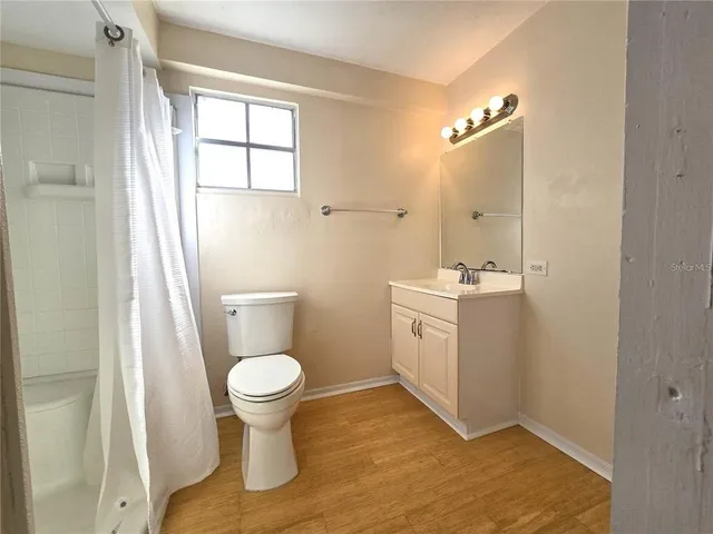 a bathroom with a toilet sink and a mirror
