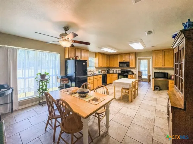 a kitchen with stainless steel appliances granite countertop a refrigerator stove microwave and sink