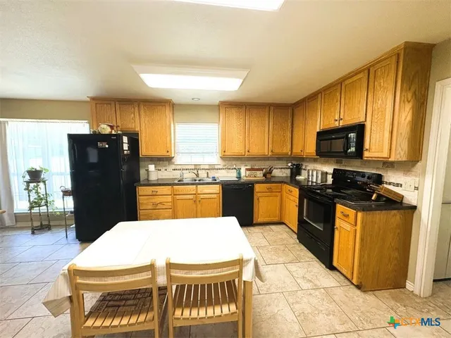 a spacious bedroom with a bed and wooden floor