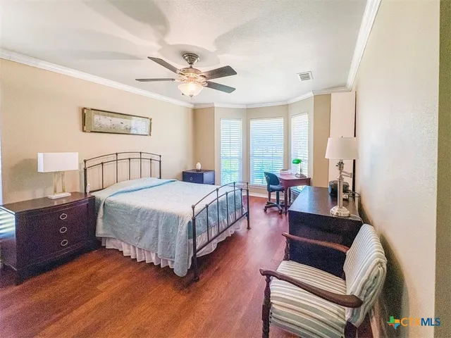 a bed sitting in a bedroom next to a window