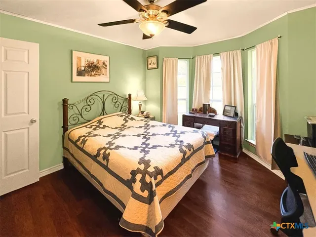 a bedroom with furniture and a flat screen tv