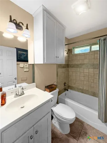 a large bathroom with a tub and shower