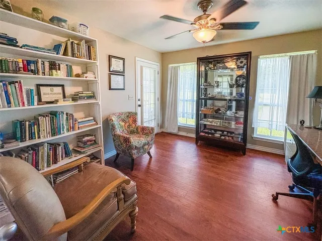 a living room with furniture a chandelier and a rug