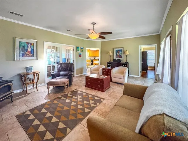 a living room with furniture a flat screen tv and a large window