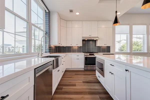 a kitchen with stainless steel appliances a stove sink and cabinets
