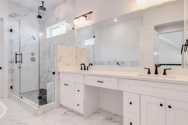 a spacious bathroom with double sink and shower