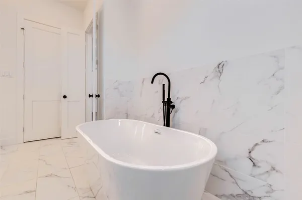 a white bath tub sitting in a bathroom