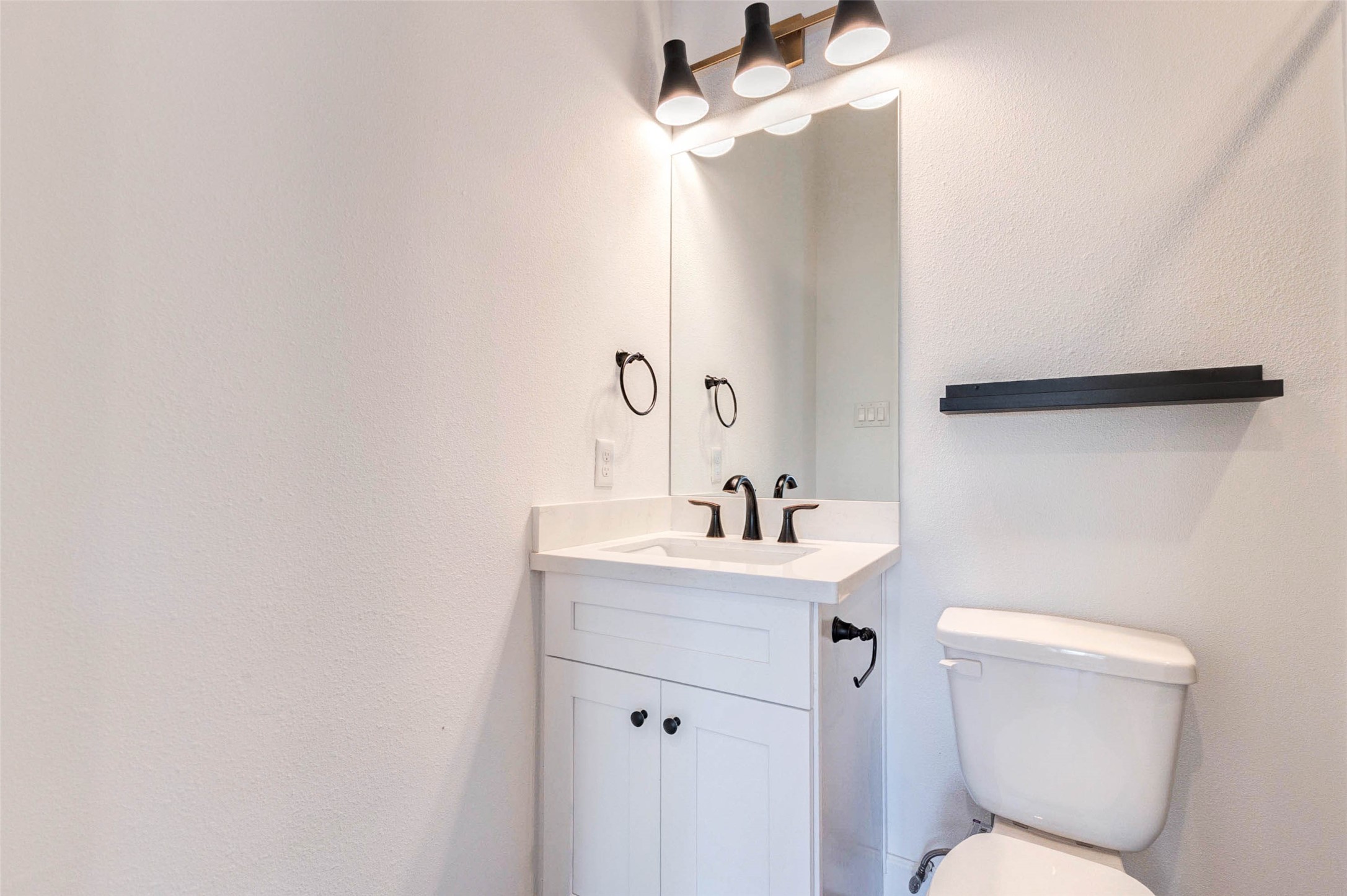 2751 Freund Street Houston, TX 77003 - Photo 5 of 34 a bathroom with a toilet a sink and mirror