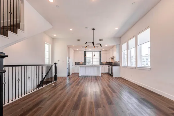 a view of kitchen with wooden floor electronic appliances and window