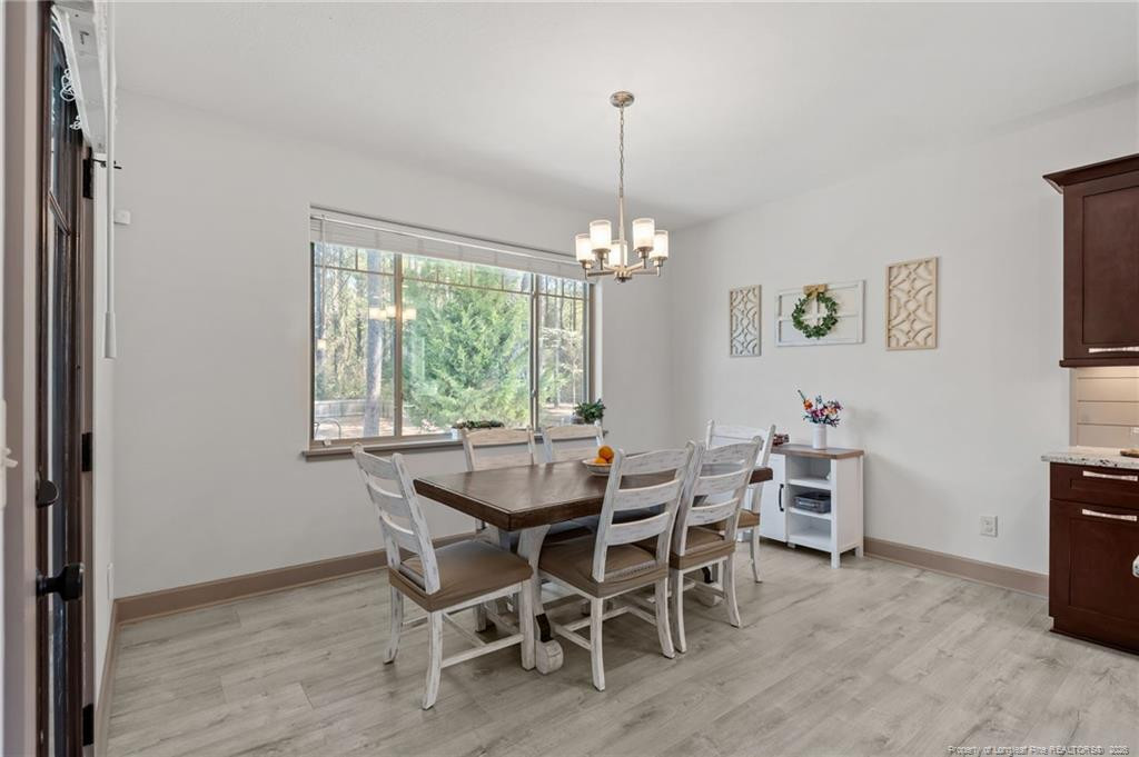 190 Devon Circle Aberdeen, NC 28315 - Photo 21 of 50 a dining room with furniture a chandelier and window