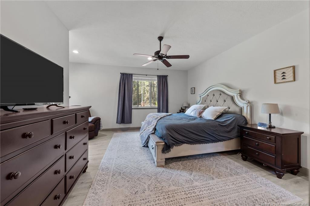190 Devon Circle Aberdeen, NC 28315 - Photo 24 of 50 a bedroom with a bed and a flat tv screen on dresser