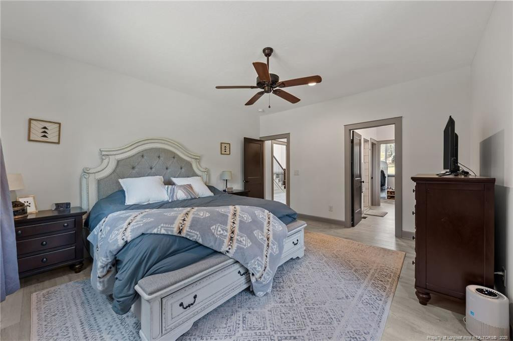 190 Devon Circle Aberdeen, NC 28315 - Photo 25 of 50 a bedroom with a bed and a chandelier