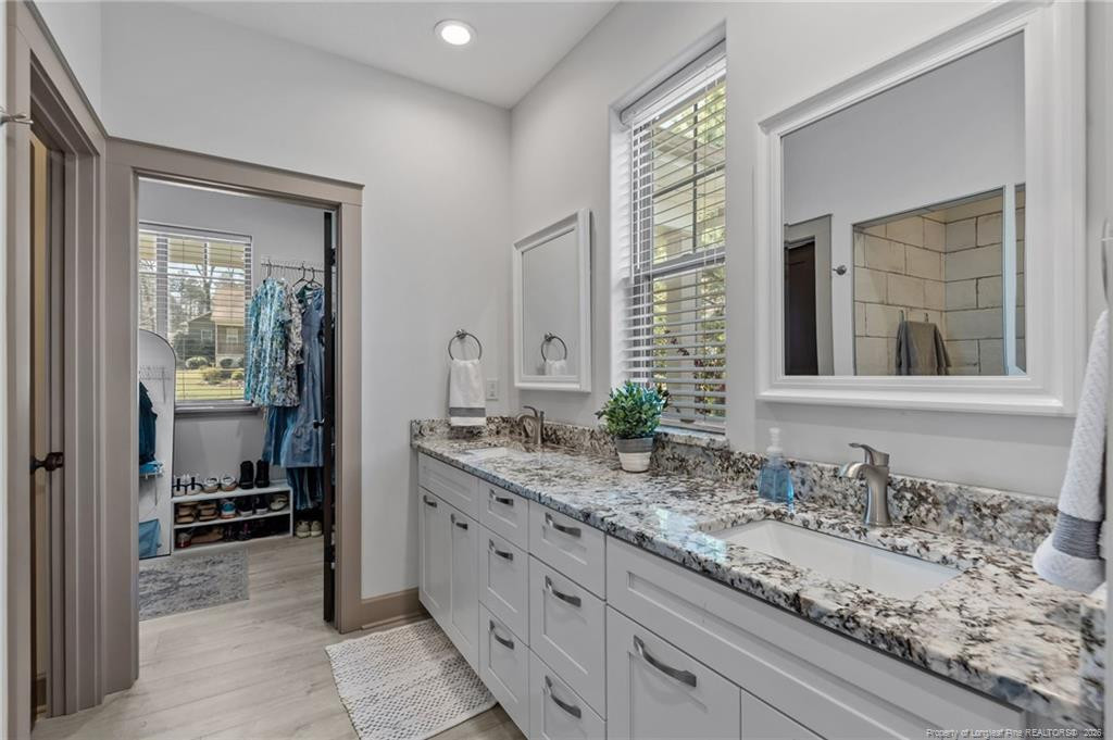 190 Devon Circle Aberdeen, NC 28315 - Photo 26 of 50 a bathroom with a granite countertop sink and a mirror