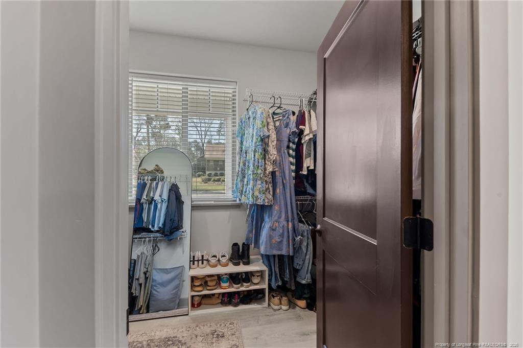 190 Devon Circle Aberdeen, NC 28315 - Photo 27 of 50 a view of walk in closet with clothes and shoes
