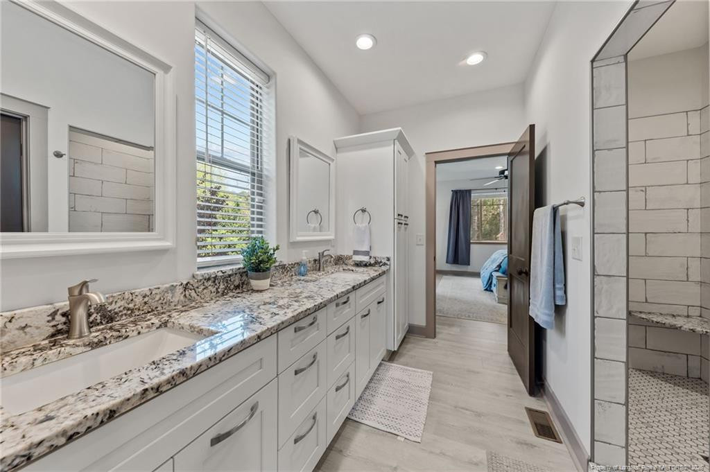 190 Devon Circle Aberdeen, NC 28315 - Photo 28 of 50 a bathroom with a granite countertop sink and a mirror