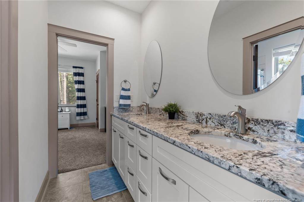 190 Devon Circle Aberdeen, NC 28315 - Photo 36 of 50 a bathroom with a granite countertop sink and a mirror