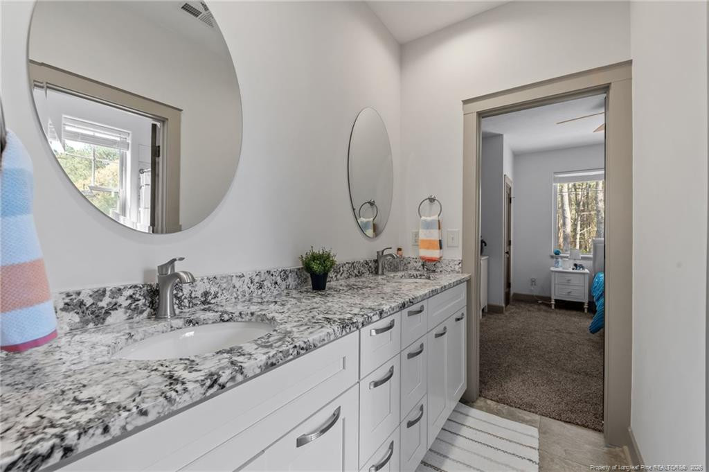 190 Devon Circle Aberdeen, NC 28315 - Photo 41 of 50 a en suite bathroom with a granite countertop sink and a mirror