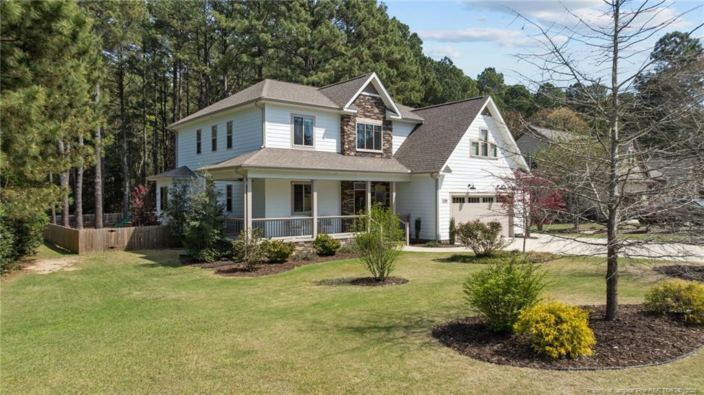 190 Devon Circle Aberdeen, NC 28315 - Photo 5 of 50 a front view of a house with garden