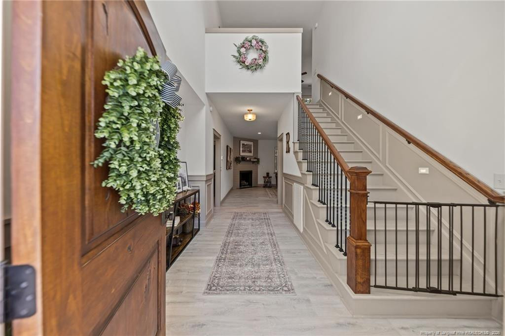 190 Devon Circle Aberdeen, NC 28315 - Photo 6 of 50 a hallway with wooden floor and stairs