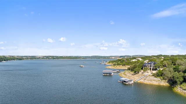 a view of a lake with beach and city space