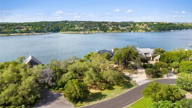 an aerial view of a houses with a lake view