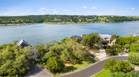 an aerial view of a houses with a lake view