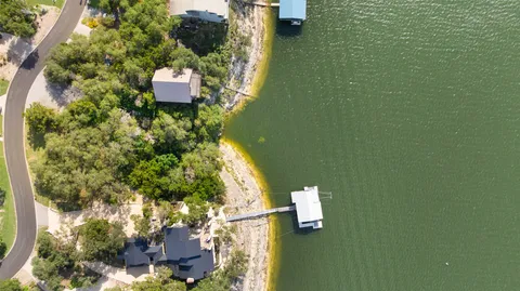 an aerial view of a house with yard swimming pool and outdoor seating