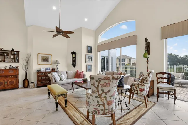 a living room with furniture large window and flat screen tv