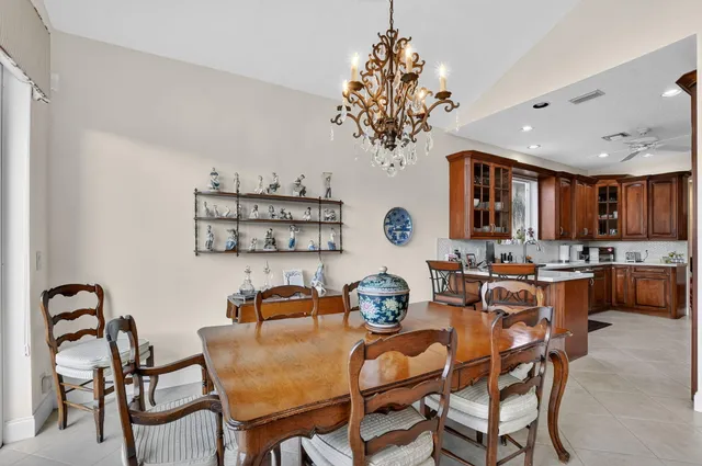 a view of a dining room with furniture and chandelier