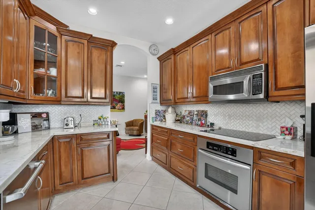 a kitchen with stainless steel appliances granite countertop a sink stove and microwave