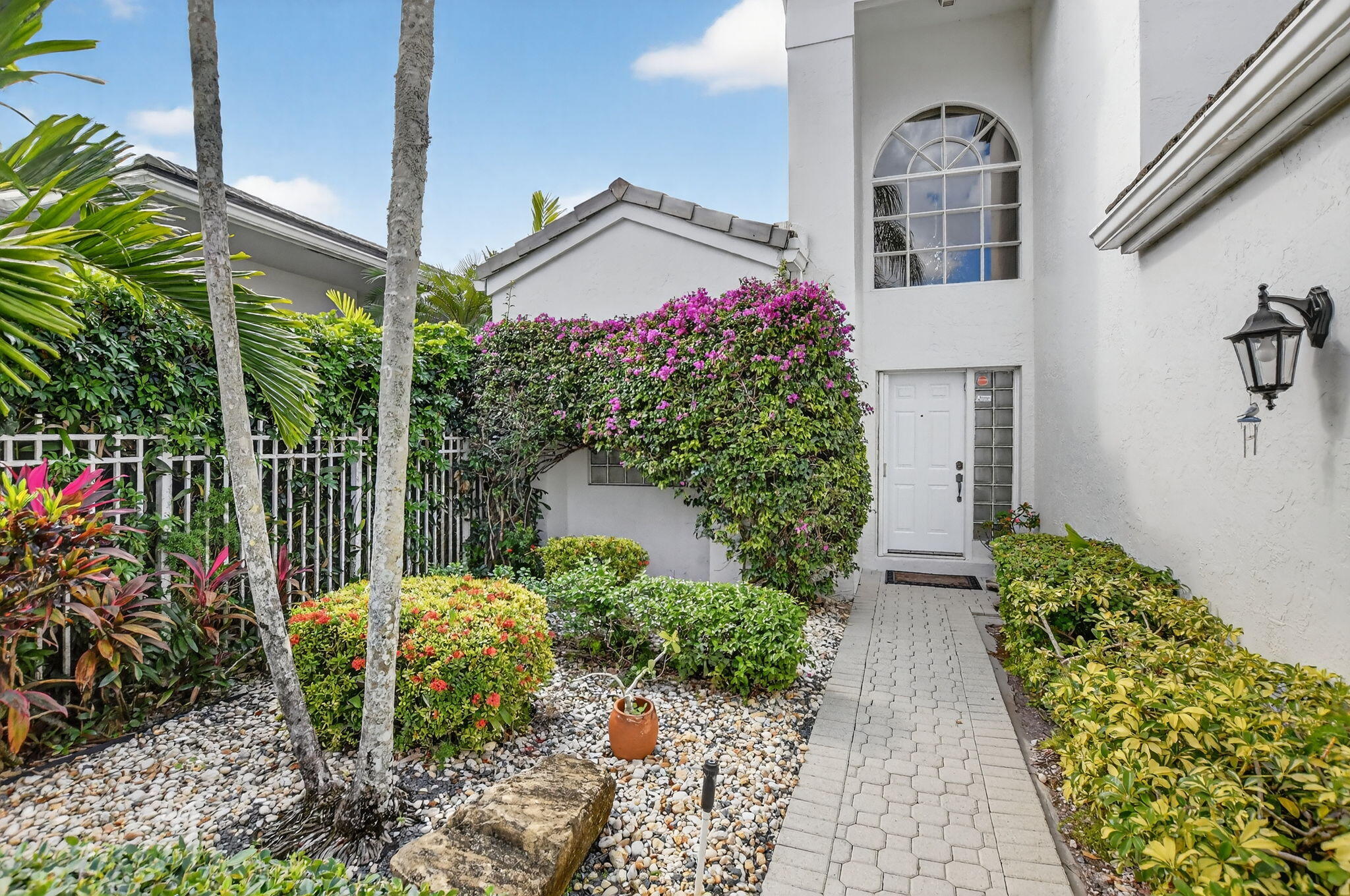 7997 Travelers Tree Drive Boca Raton, FL 33433 - Photo 3 of 54 a view of a house with a flower garden