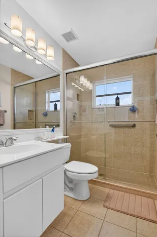 a bedroom with a bed dresser and mirror