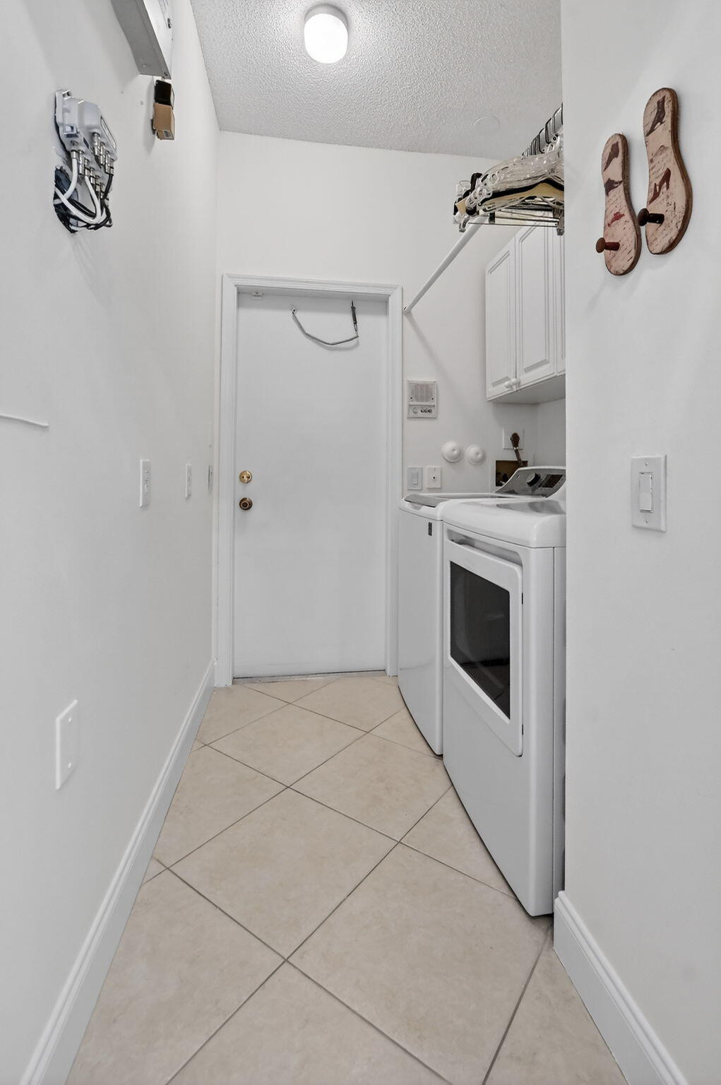 7997 Travelers Tree Drive Boca Raton, FL 33433 - Photo 39 of 54 a view of a storage & utility room with washer and dryer