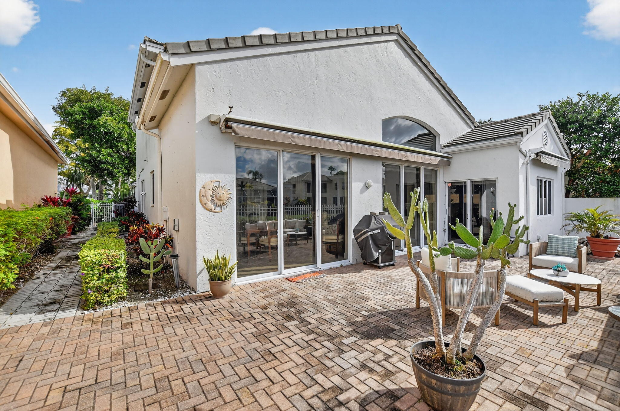 7997 Travelers Tree Drive Boca Raton, FL 33433 - Photo 41 of 54 a view of a house with backyard sitting area and garden