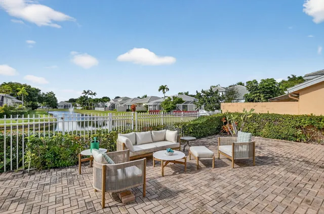 an aerial view of a house with a swimming pool and outdoor seating